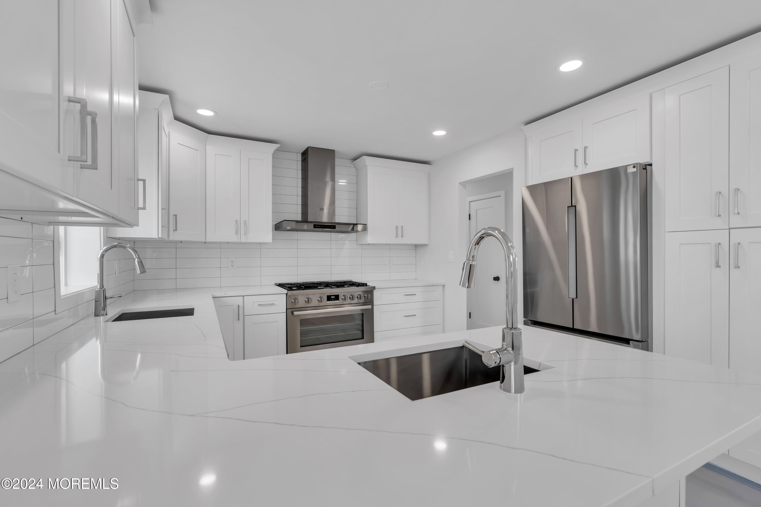 44 Lexington Road Howell, NJ 07731 - Photo 17 of 45 a kitchen with stainless steel appliances a refrigerator sink and cabinets