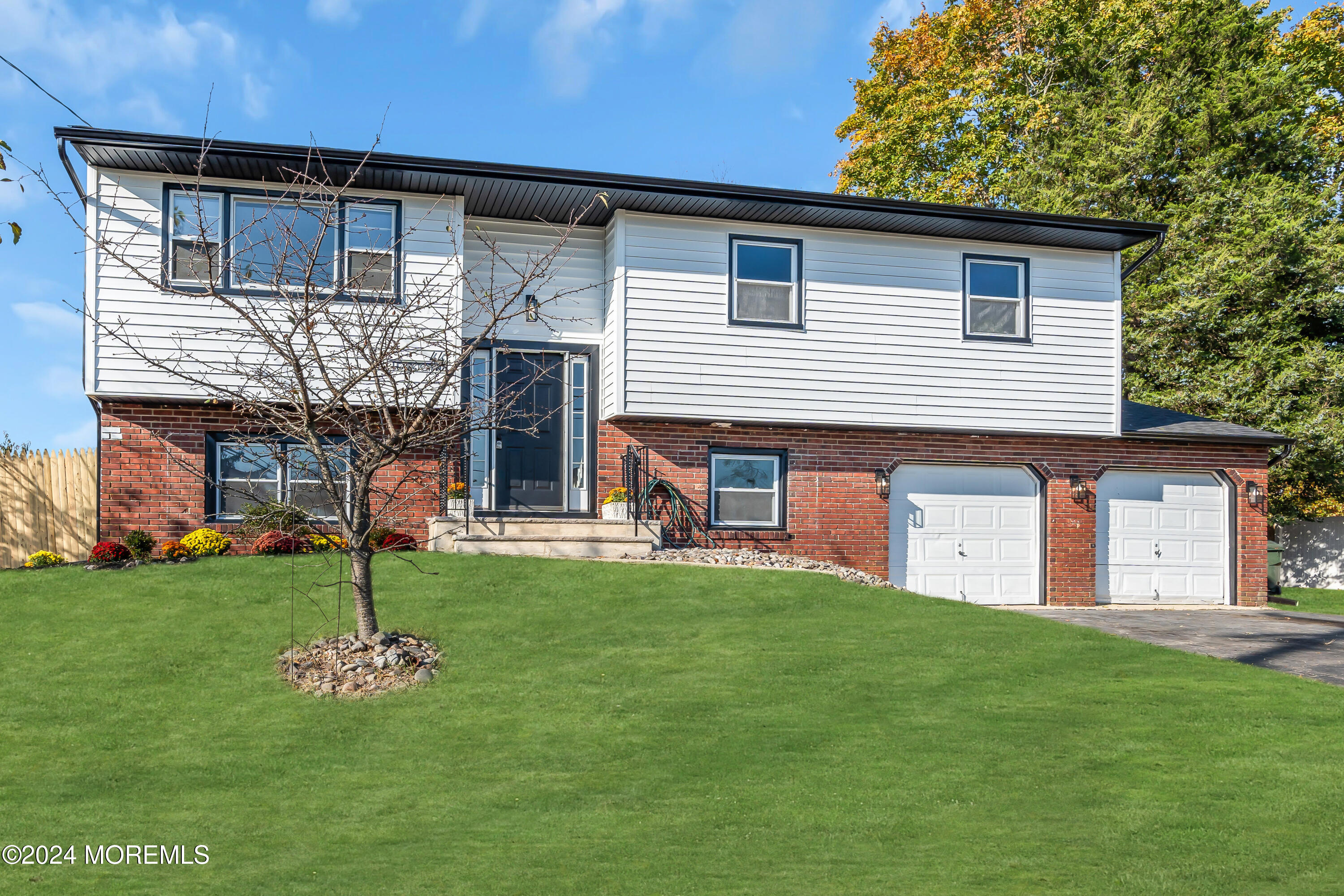 44 Lexington Road Howell, NJ 07731 - Photo 2 of 45 a front view of a house with a garden
