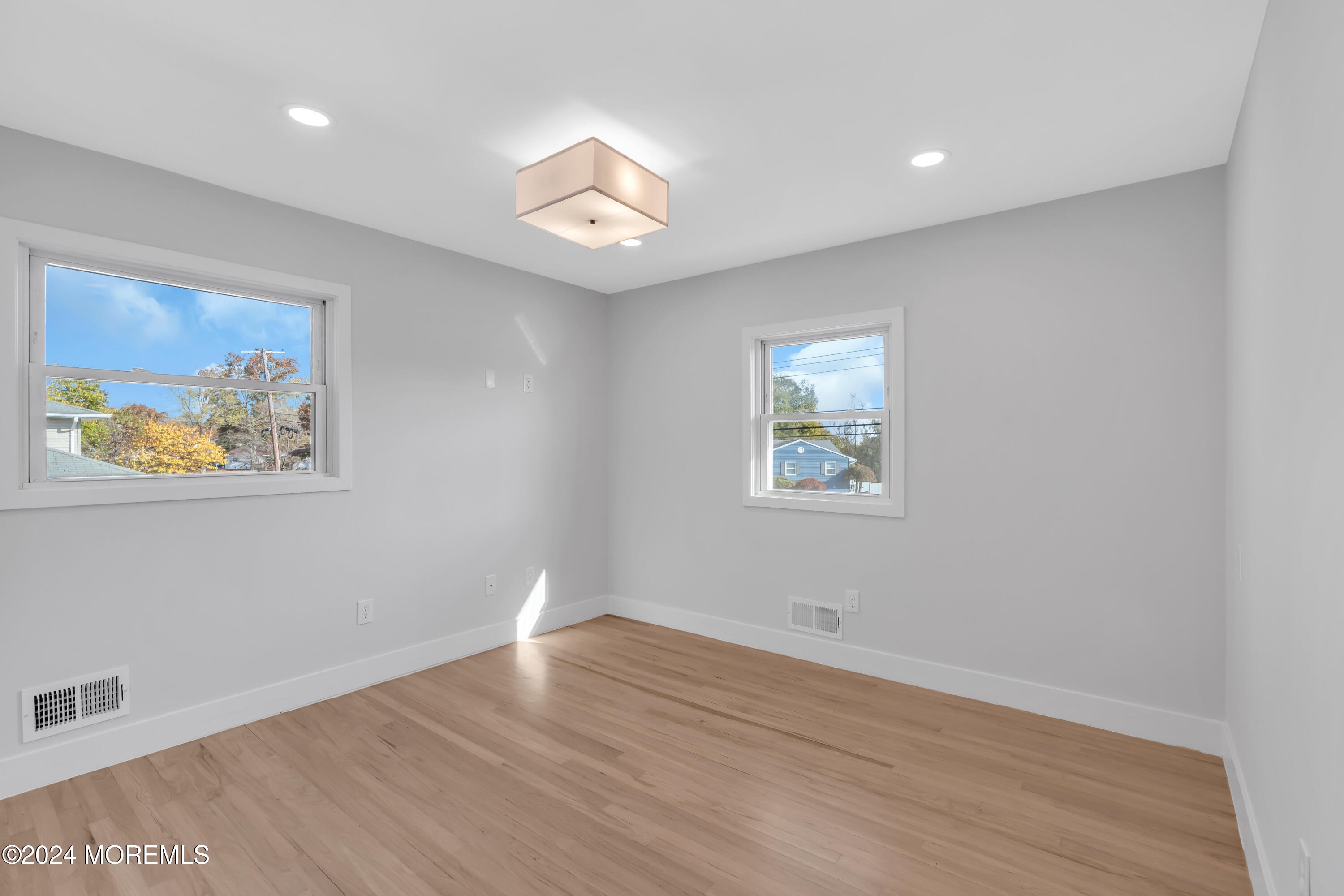44 Lexington Road Howell, NJ 07731 - Photo 24 of 45 a view of an empty room with wooden floor and a window