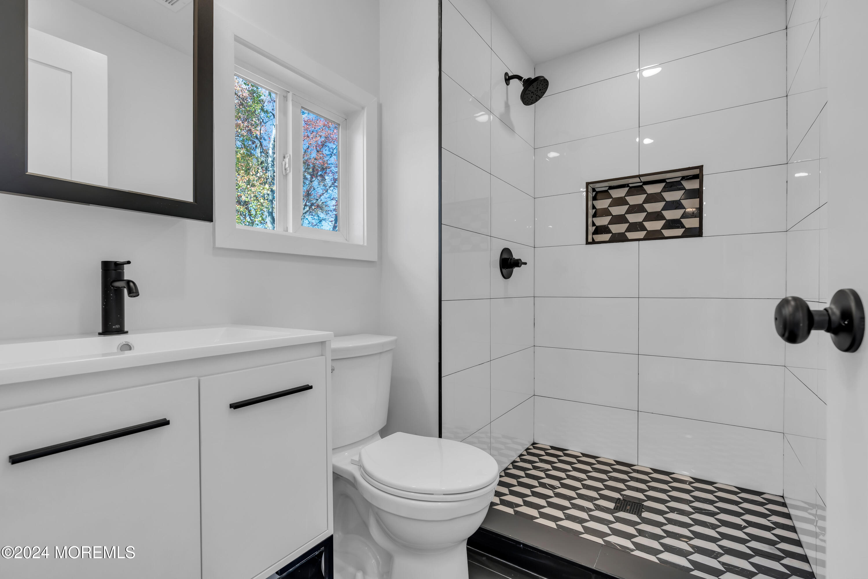 44 Lexington Road Howell, NJ 07731 - Photo 33 of 45 a bathroom with a toilet a sink and mirror