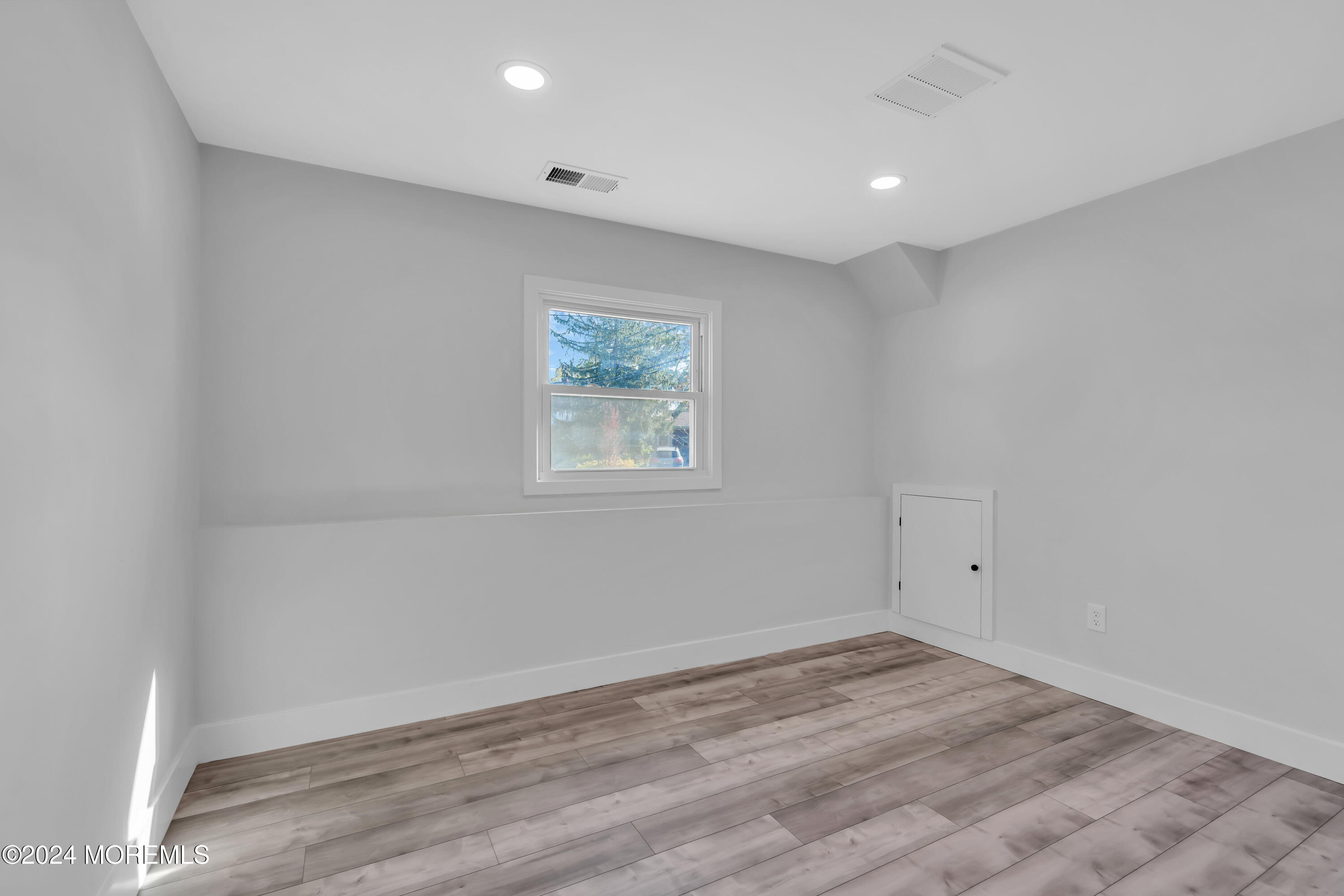 44 Lexington Road Howell, NJ 07731 - Photo 35 of 45 an empty room with wooden floor and window