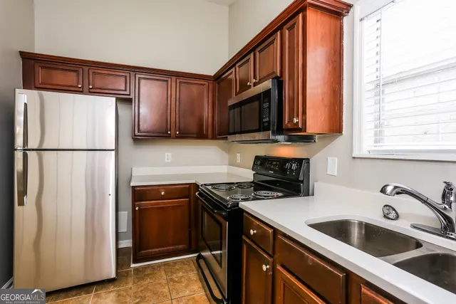 a stove top oven sitting inside of a kitchen