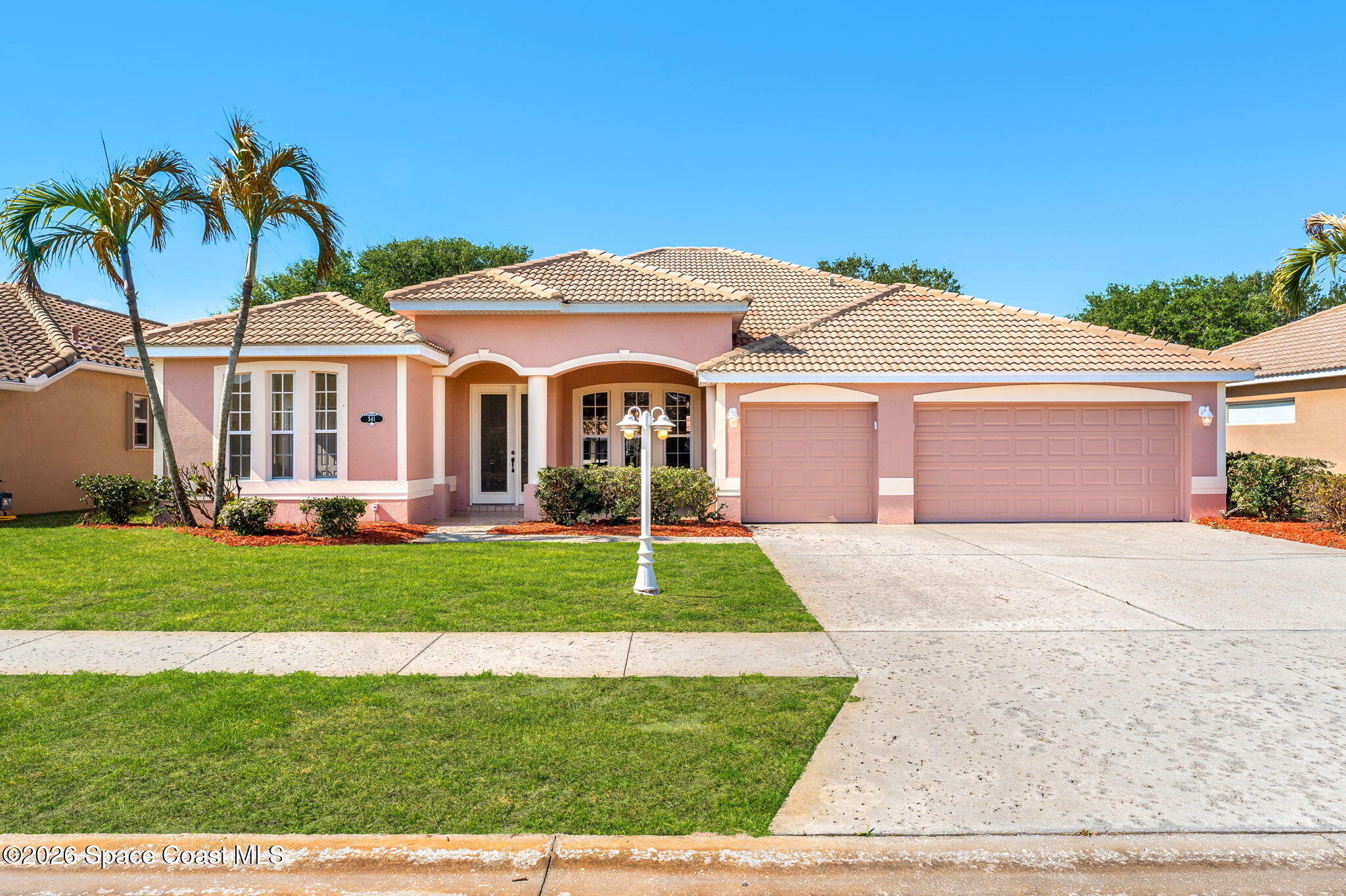 541 Oceanside Boulevard Indialantic, FL 32903 - Photo 1 of 51 a front view of a house with a garden and yard