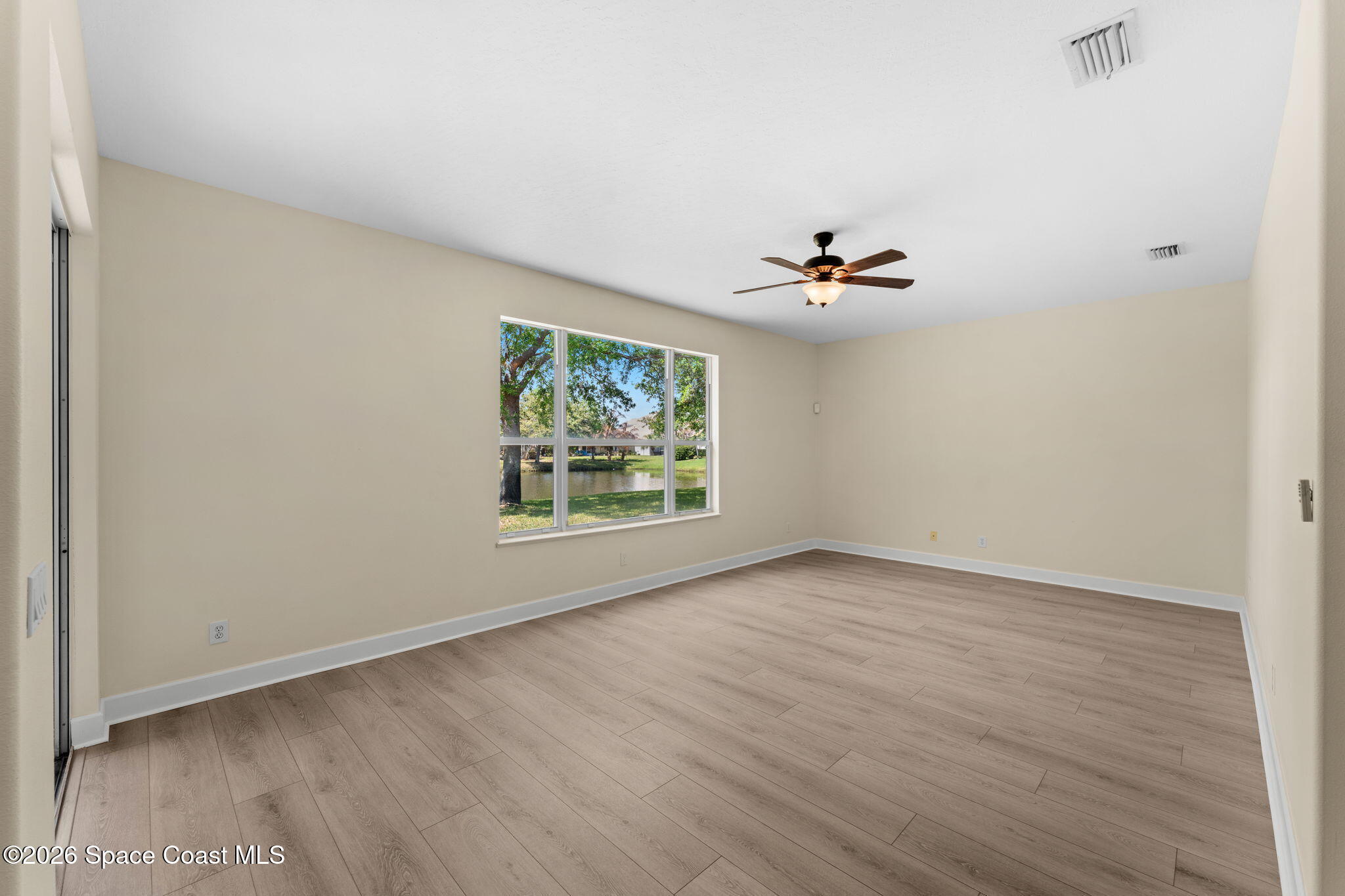541 Oceanside Boulevard Indialantic, FL 32903 - Photo 17 of 51 an empty room with a window and a ceiling fan
