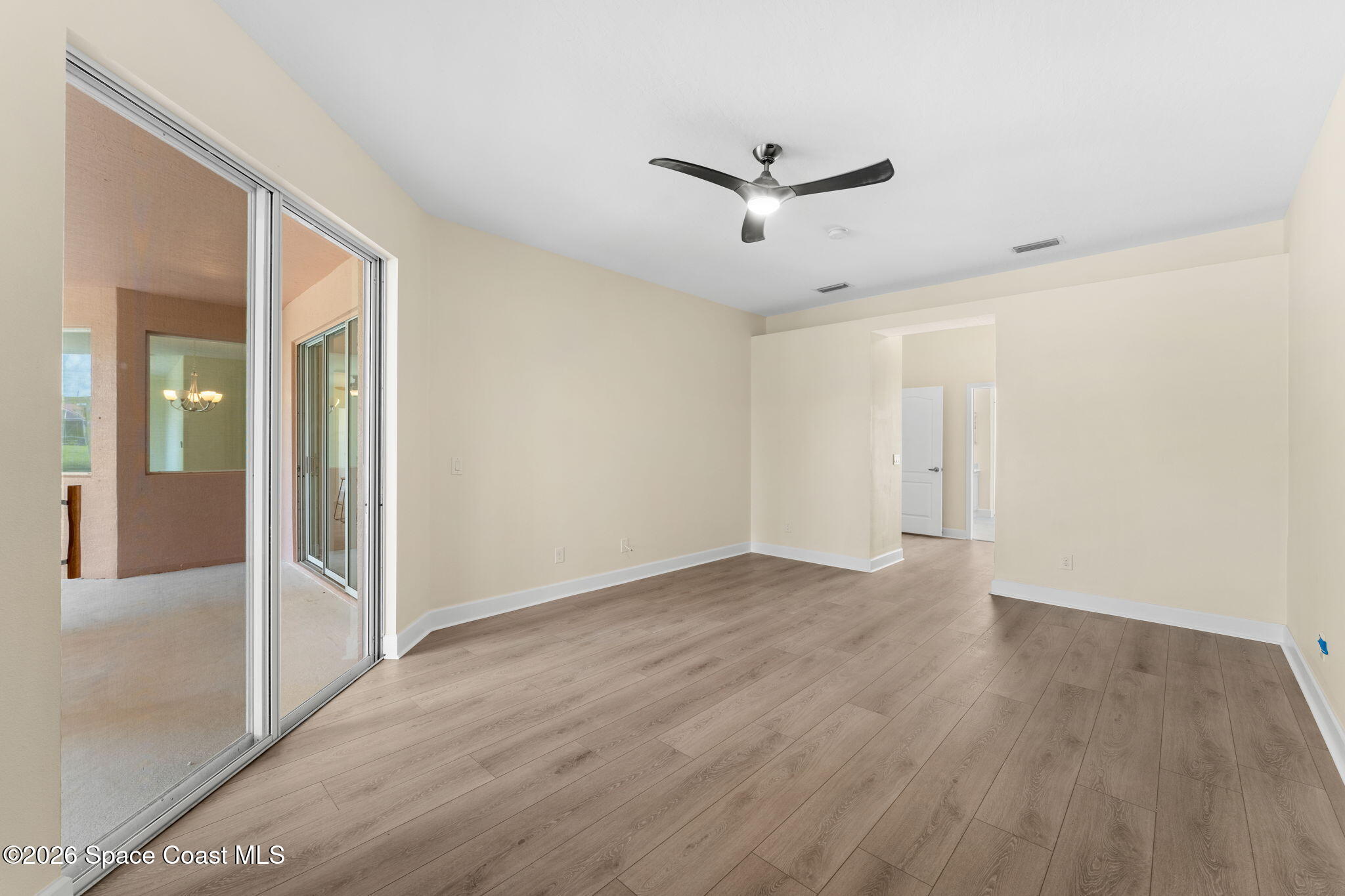 541 Oceanside Boulevard Indialantic, FL 32903 - Photo 19 of 51 a view of a big room with wooden floor closet and windows