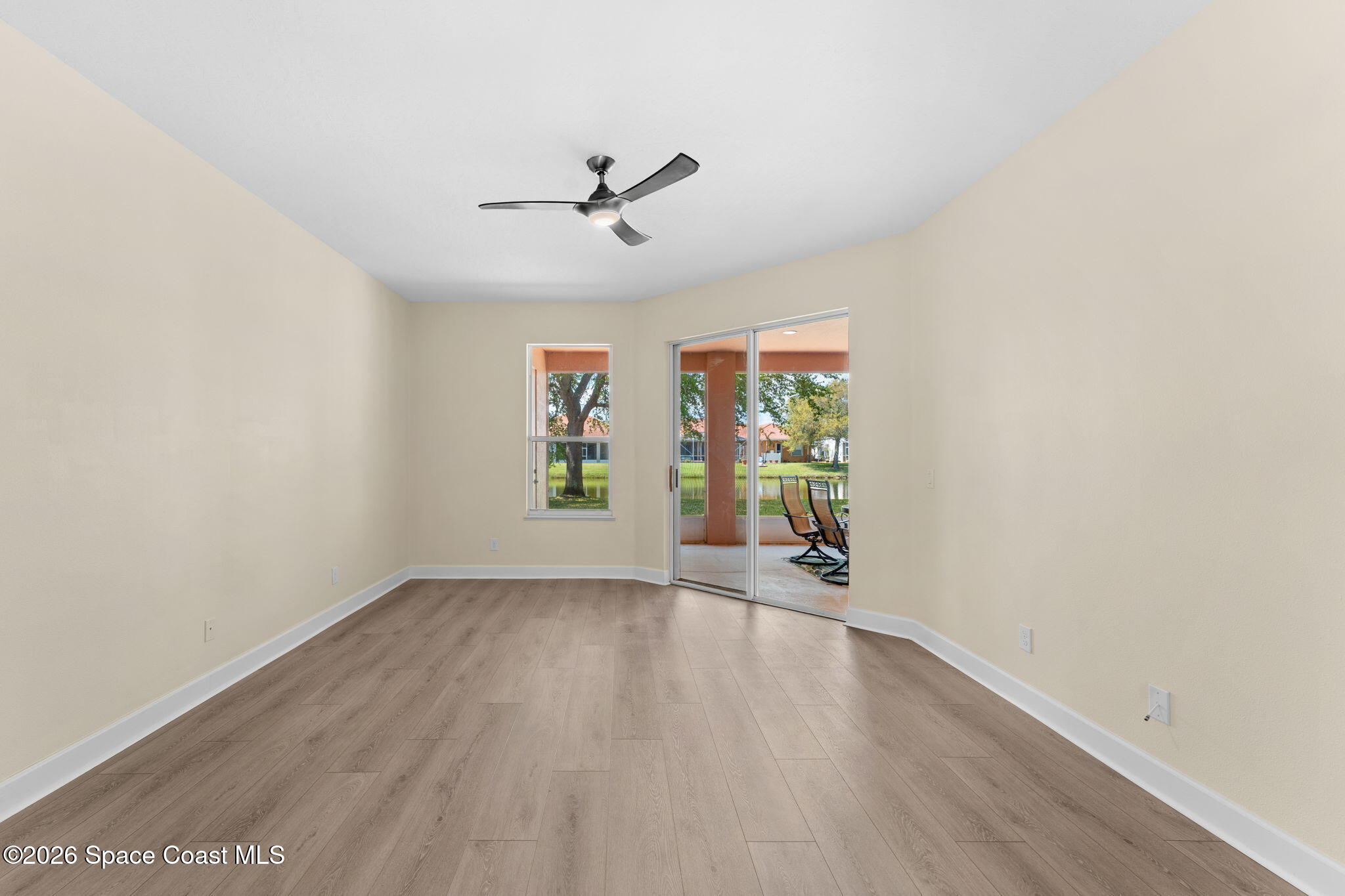541 Oceanside Boulevard Indialantic, FL 32903 - Photo 20 of 51 an empty room with wooden floor fan and windows