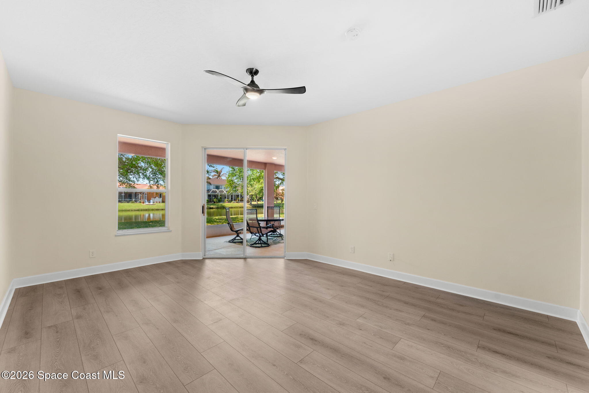 541 Oceanside Boulevard Indialantic, FL 32903 - Photo 21 of 51 a view of an empty room with wooden floor and a window