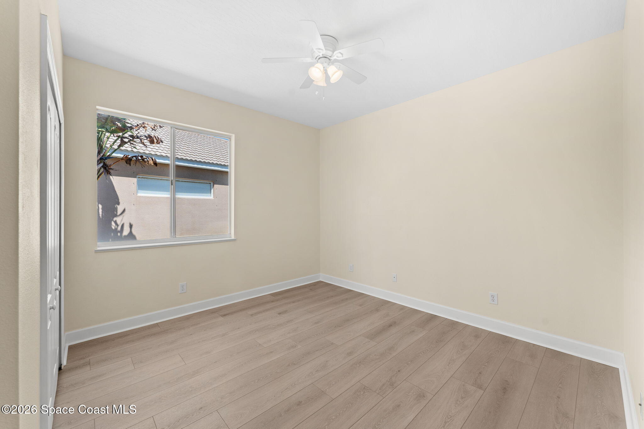 541 Oceanside Boulevard Indialantic, FL 32903 - Photo 26 of 51 an empty room with a window and a ceiling fan