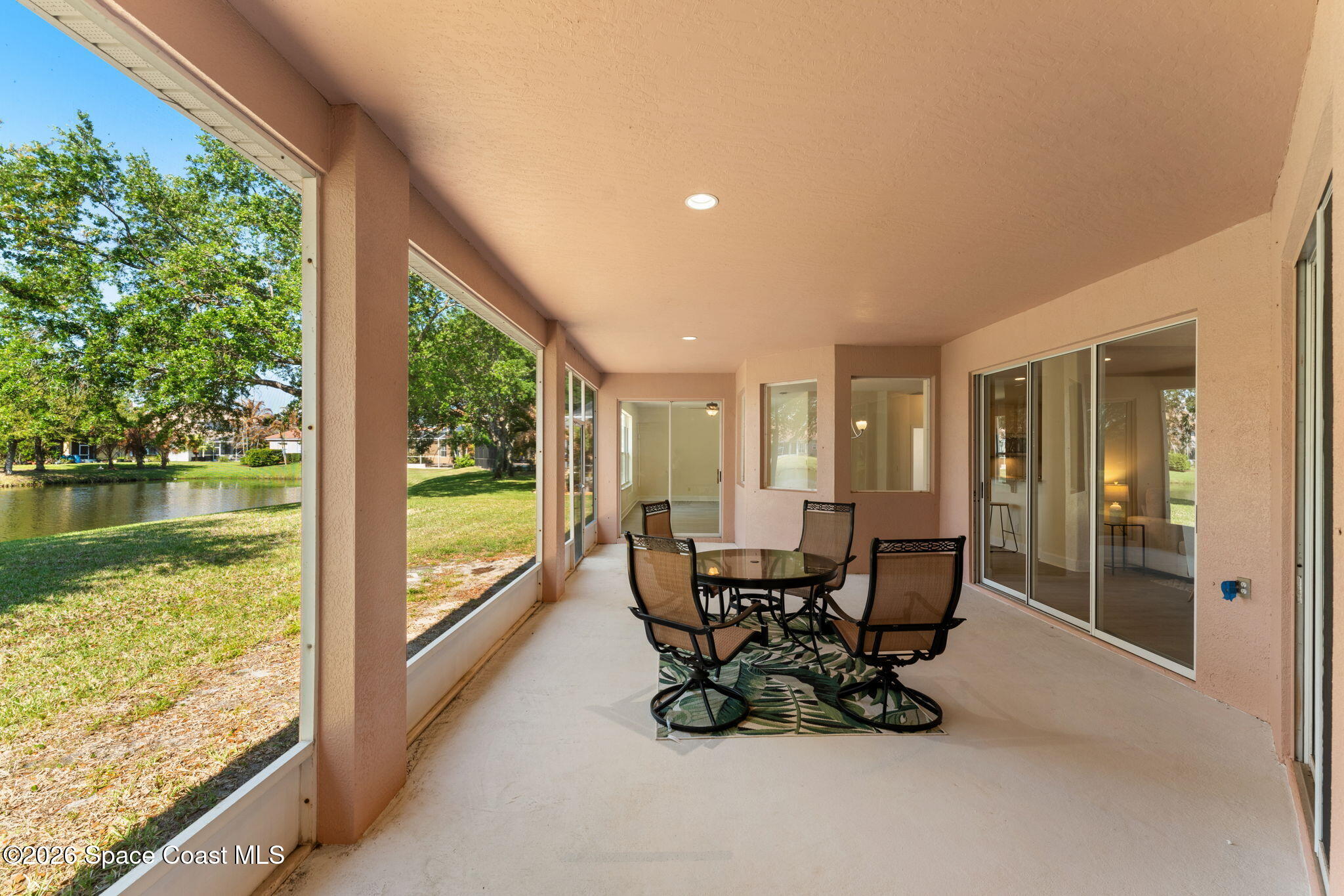 541 Oceanside Boulevard Indialantic, FL 32903 - Photo 32 of 51 a view of a patio with table and chairs and floor to ceiling window