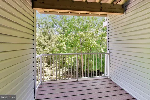 a view of a balcony with floor to ceiling window with wooden floor