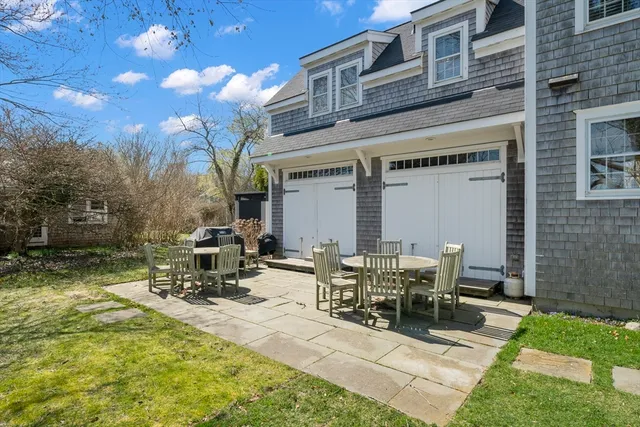 a view of a patio with table and chairs with wooden fence
