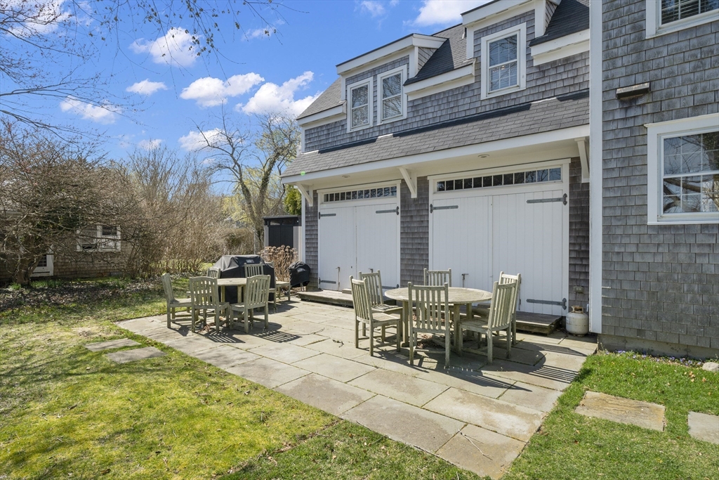 25 Washington Street Nantucket, MA 02554 - Photo 13 of 13 a view of a patio with table and chairs with wooden fence