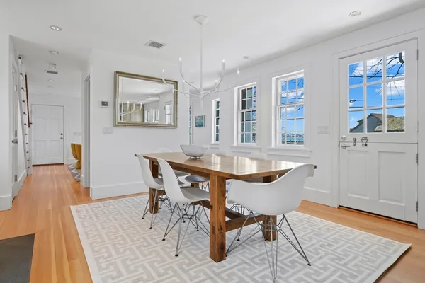 a dining room with furniture and wooden floor
