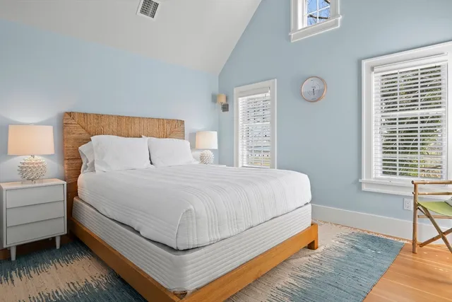 a bed sitting in a bedroom next to a window