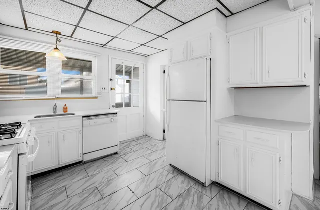 a bedroom with a bed and a window with wooden floor