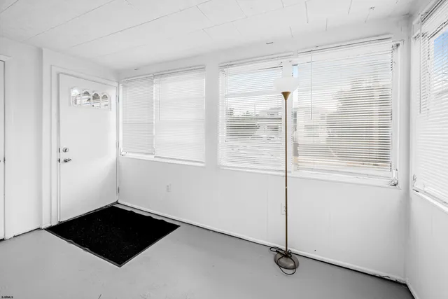 a view of a closet area with an empty room