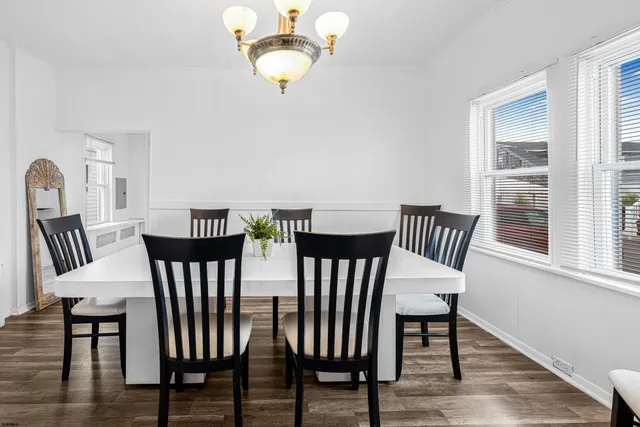 a view of a dining room with furniture wooden floor and chandelier