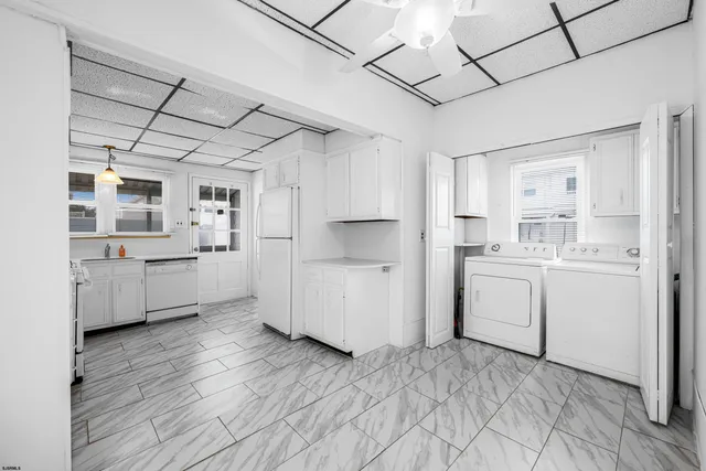 a kitchen with stainless steel appliances a refrigerator and a stove top oven