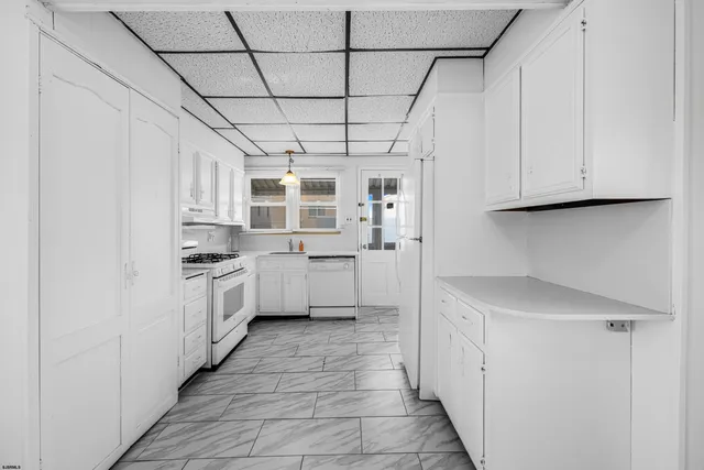 a kitchen with a stove a sink and a refrigerator