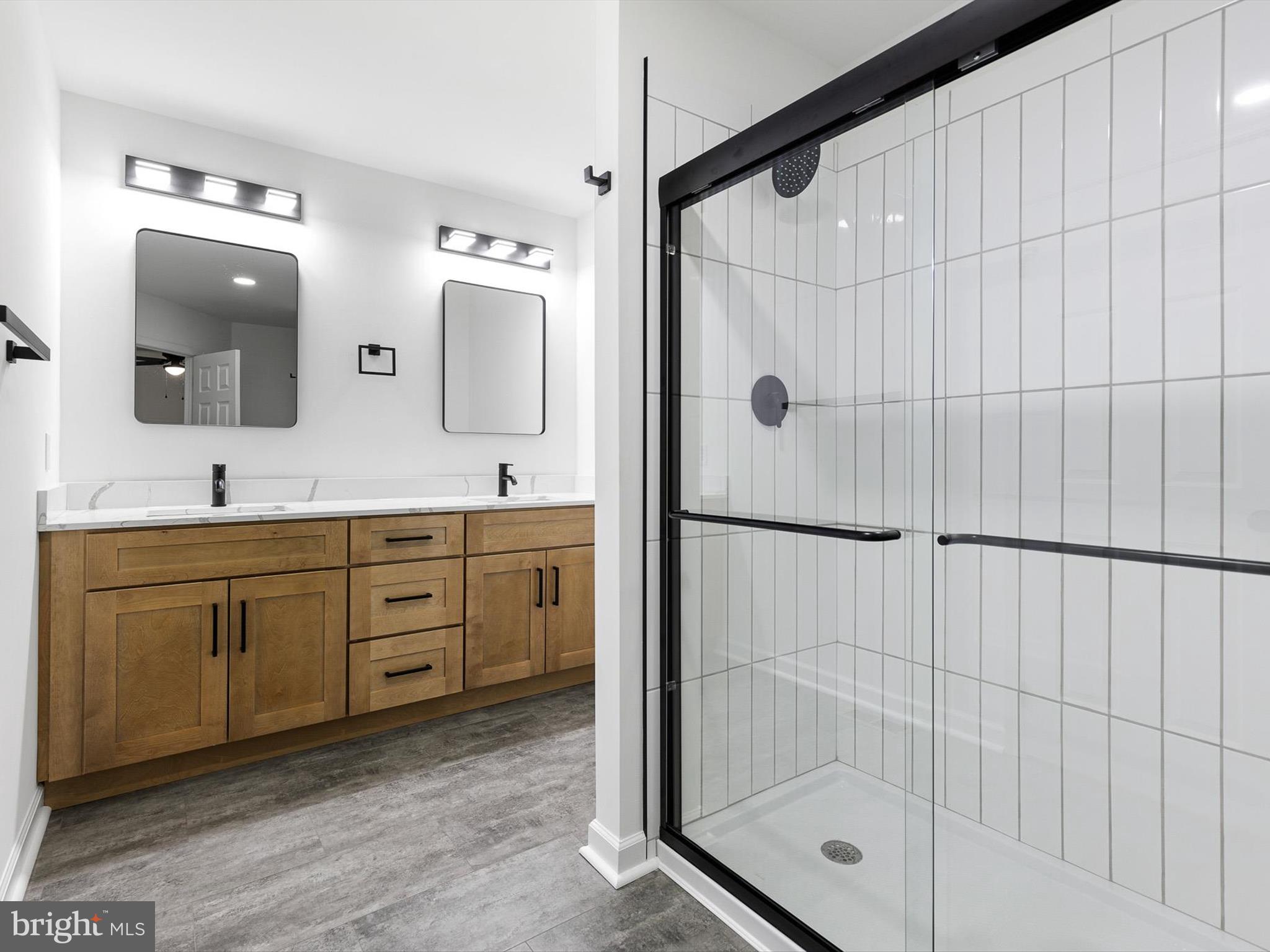 14 3 Rivers Court Newark, DE 19702 - Photo 15 of 21 a bathroom with a shower sink and mirror