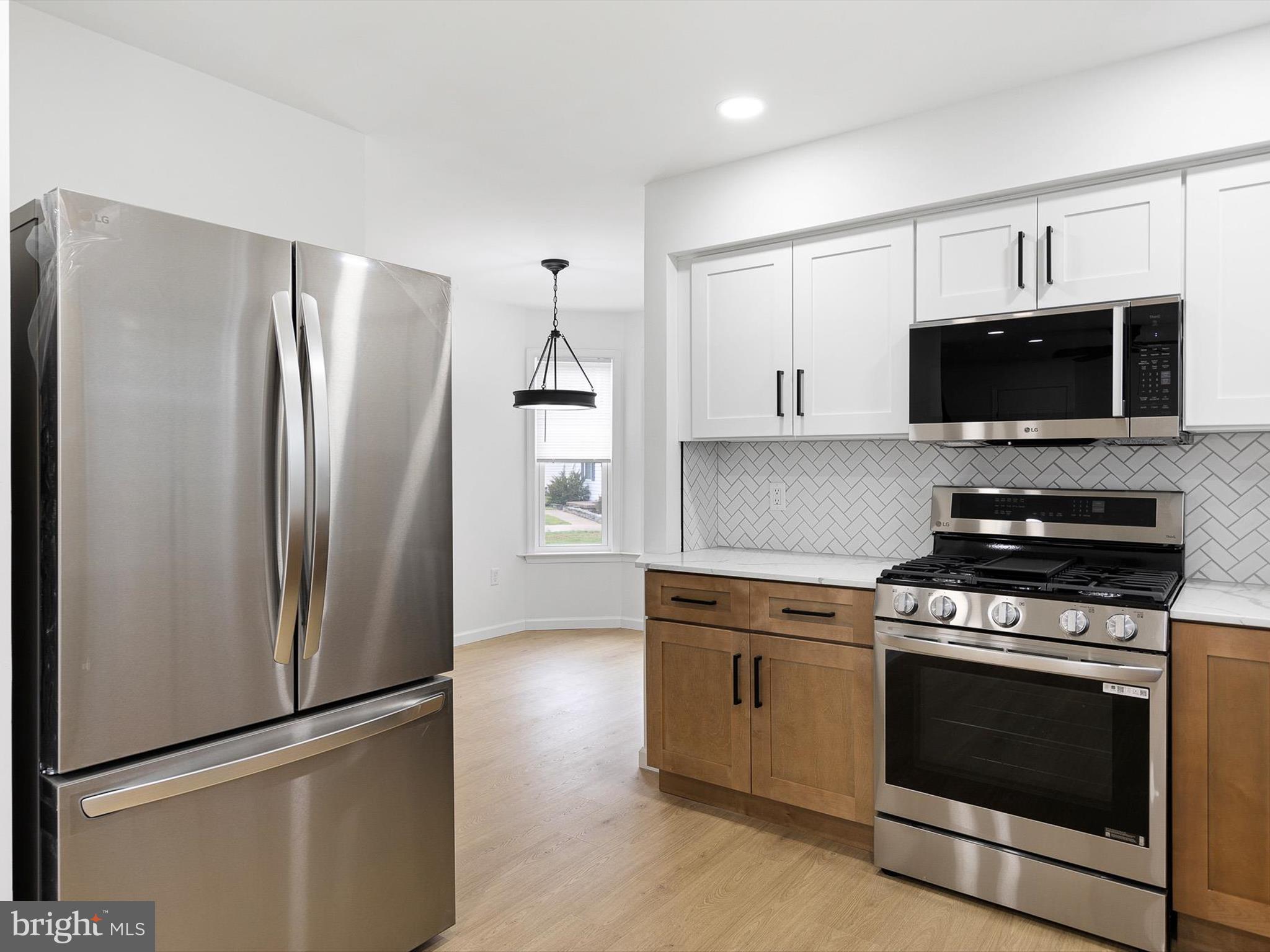 14 3 Rivers Court Newark, DE 19702 - Photo 4 of 21 a kitchen with stainless steel appliances a refrigerator a stove top oven a sink and dishwasher