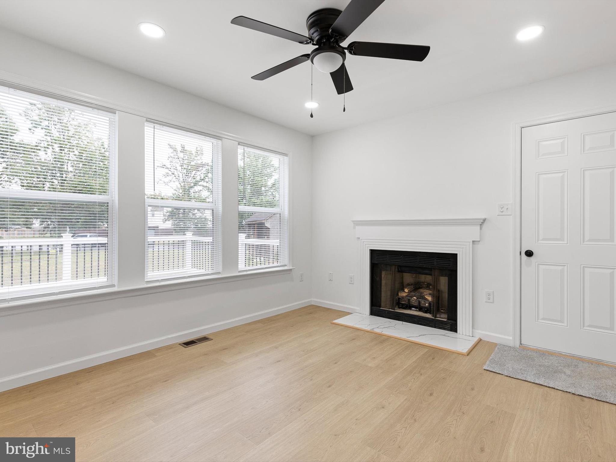 14 3 Rivers Court Newark, DE 19702 - Photo 6 of 21 a view of empty room with a fireplace and windows