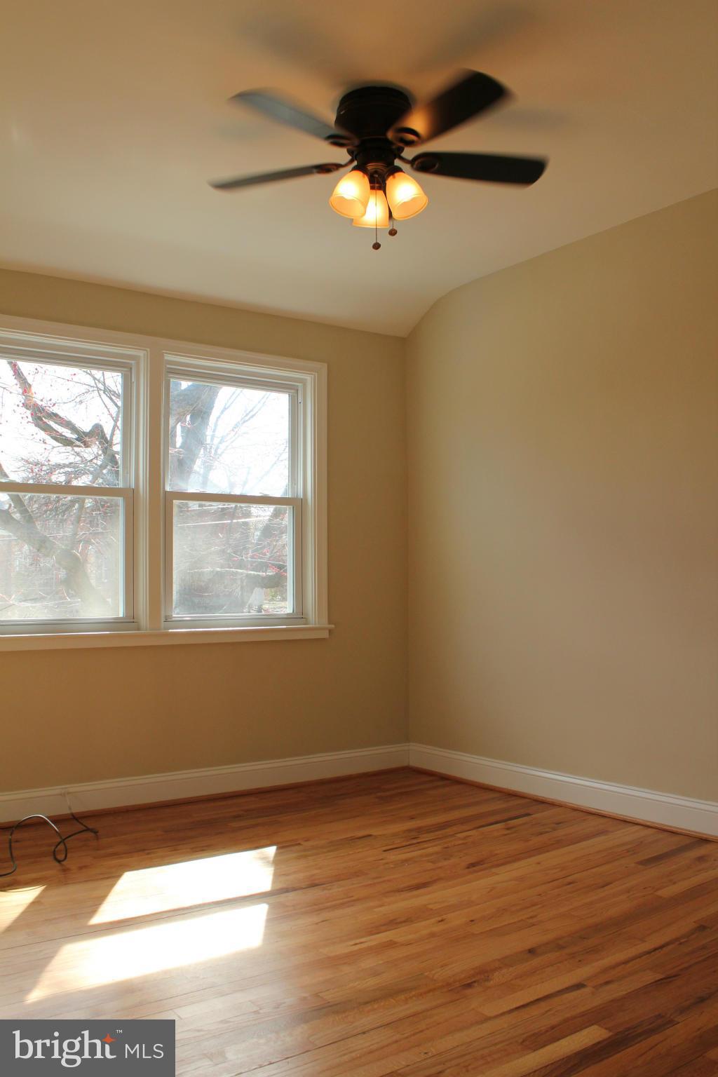 1015 Upnor Road Baltimore, MD 21212 - Photo 13 of 30 a view of an empty room with wooden floor and a window