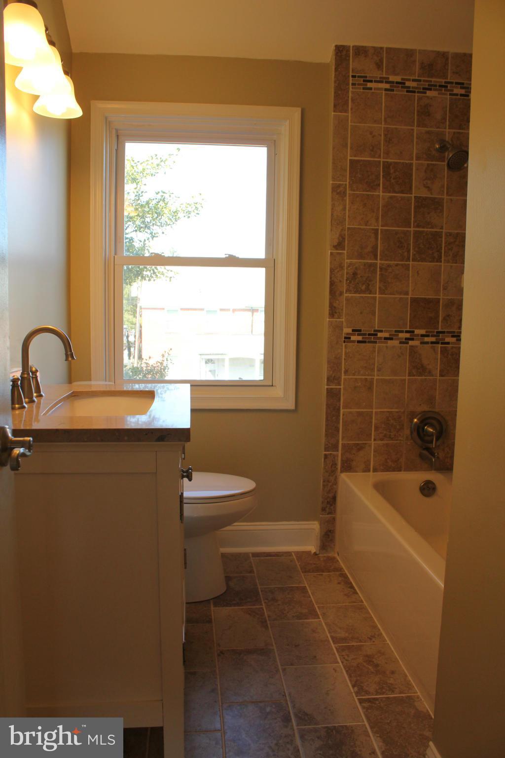 1015 Upnor Road Baltimore, MD 21212 - Photo 17 of 30 a bathroom with a sink toilet and shower