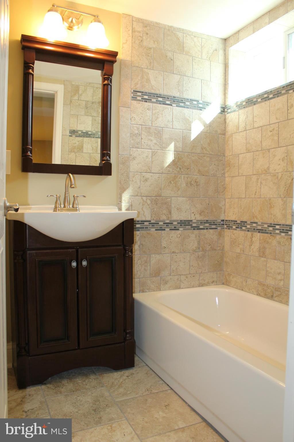 1015 Upnor Road Baltimore, MD 21212 - Photo 27 of 30 a bathroom with a bathtub and a sink