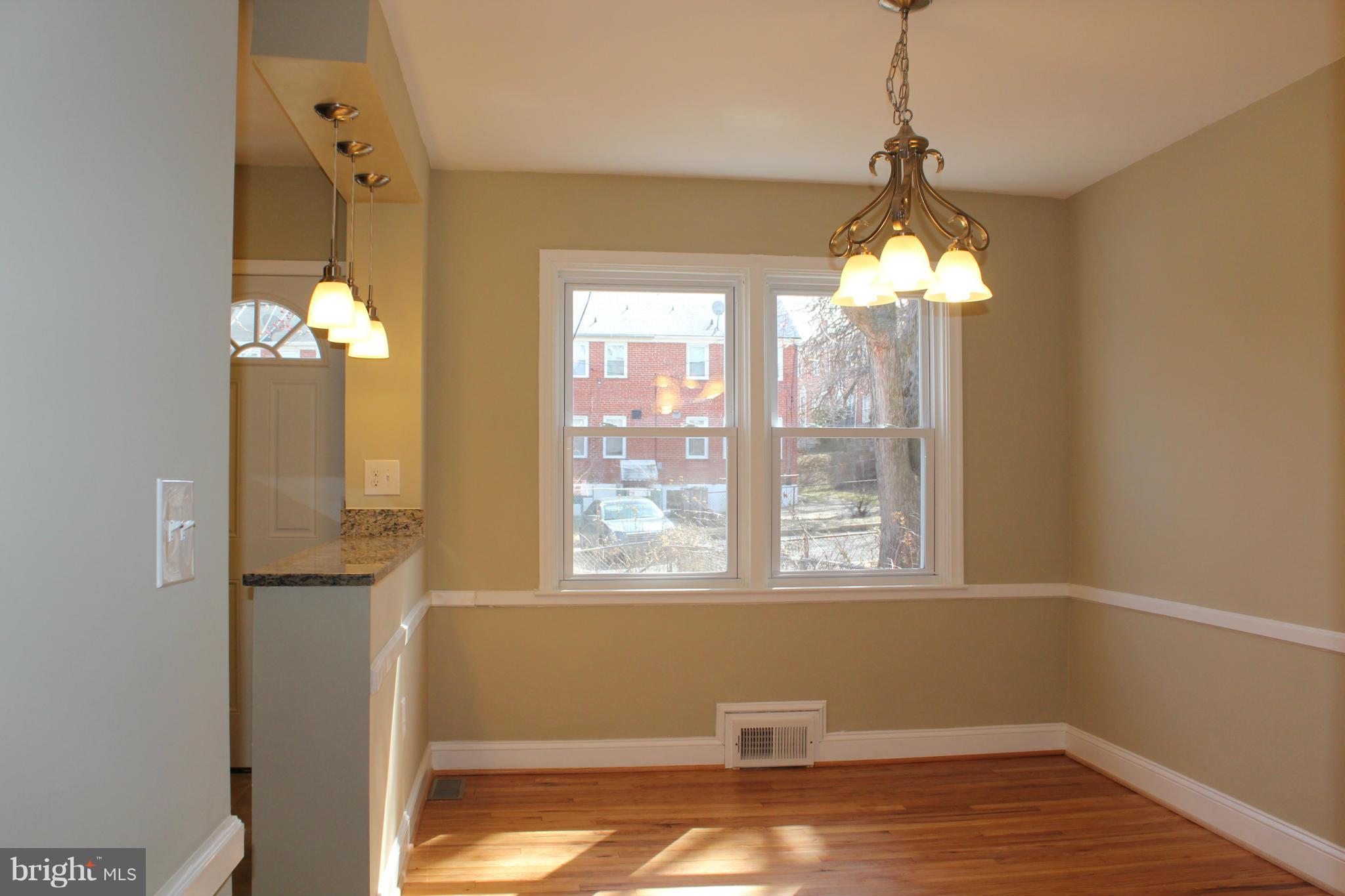 1015 Upnor Road Baltimore, MD 21212 - Photo 4 of 30 a view of a room with window wooden floor and chandelier