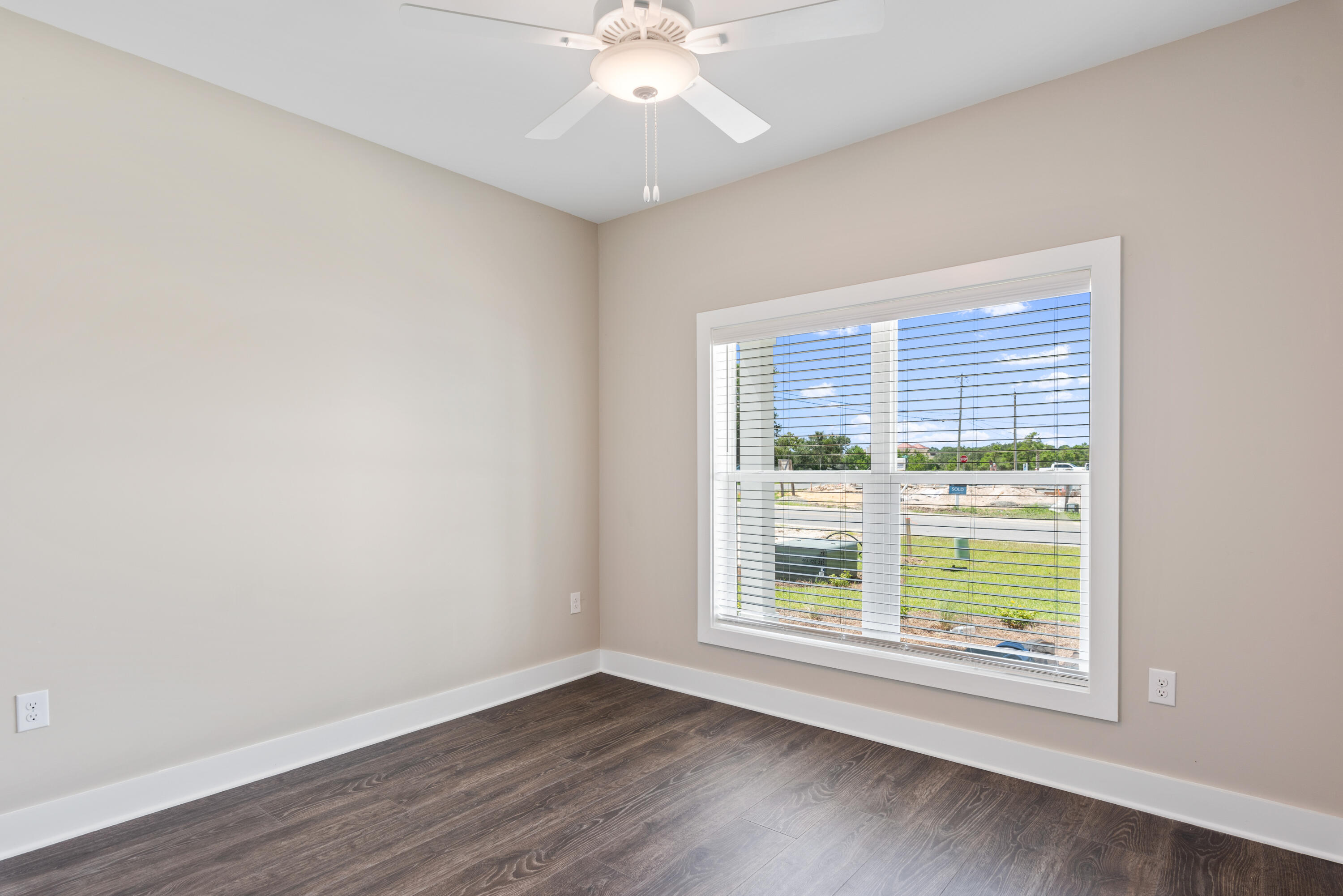 22801 Ann Miller Road Panama City Beach, FL 32413 - Photo 12 of 52 a view of an empty room with wooden floor and a window