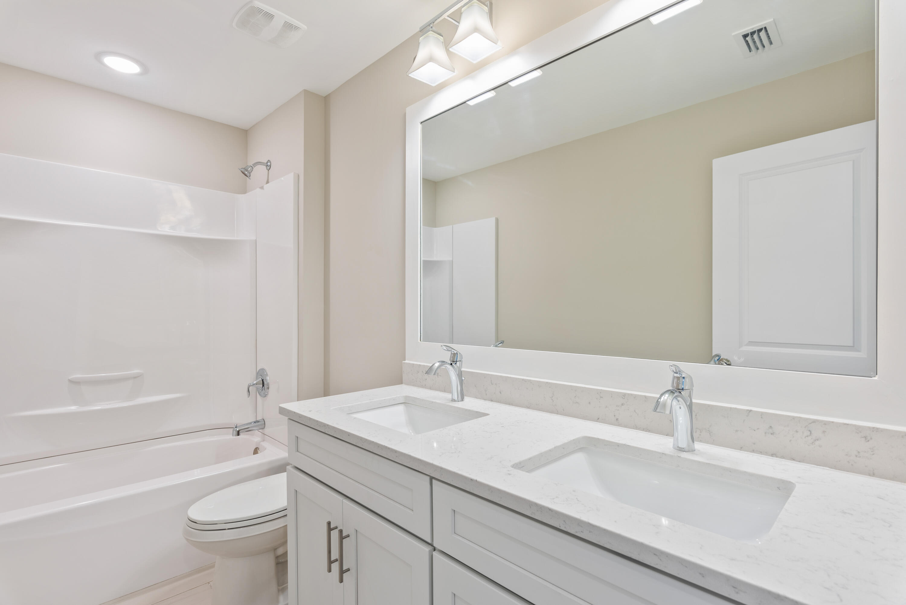 22801 Ann Miller Road Panama City Beach, FL 32413 - Photo 19 of 52 a bathroom with a sink a toilet and a large mirror