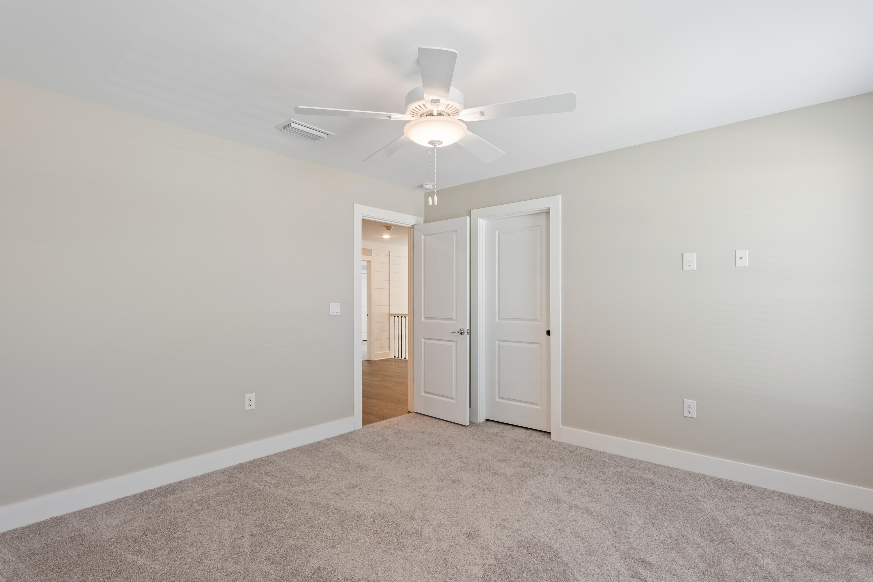 22801 Ann Miller Road Panama City Beach, FL 32413 - Photo 21 of 52 a view of an empty room with a chandelier fan