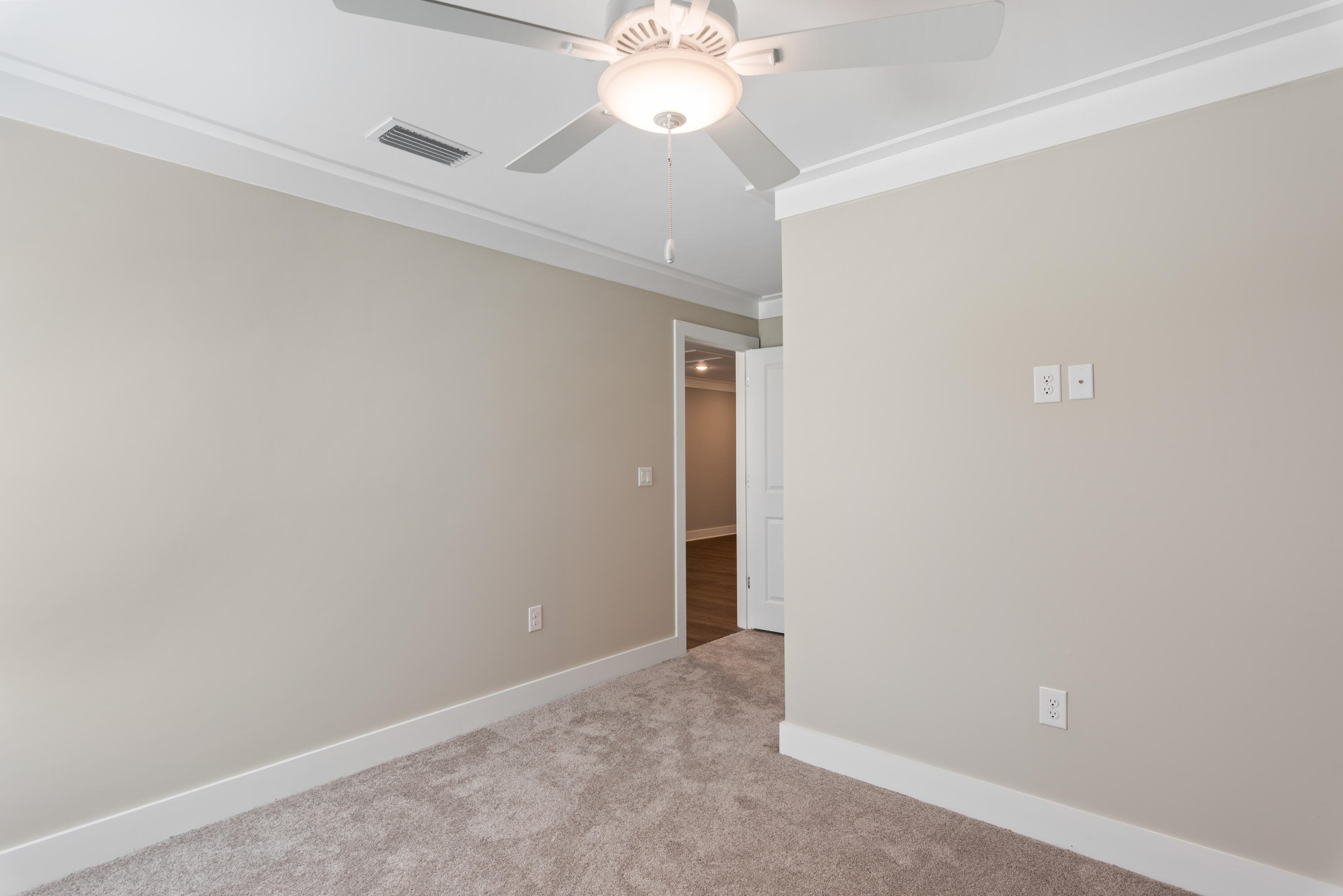 22801 Ann Miller Road Panama City Beach, FL 32413 - Photo 23 of 52 an empty room with a chandelier fan and windows