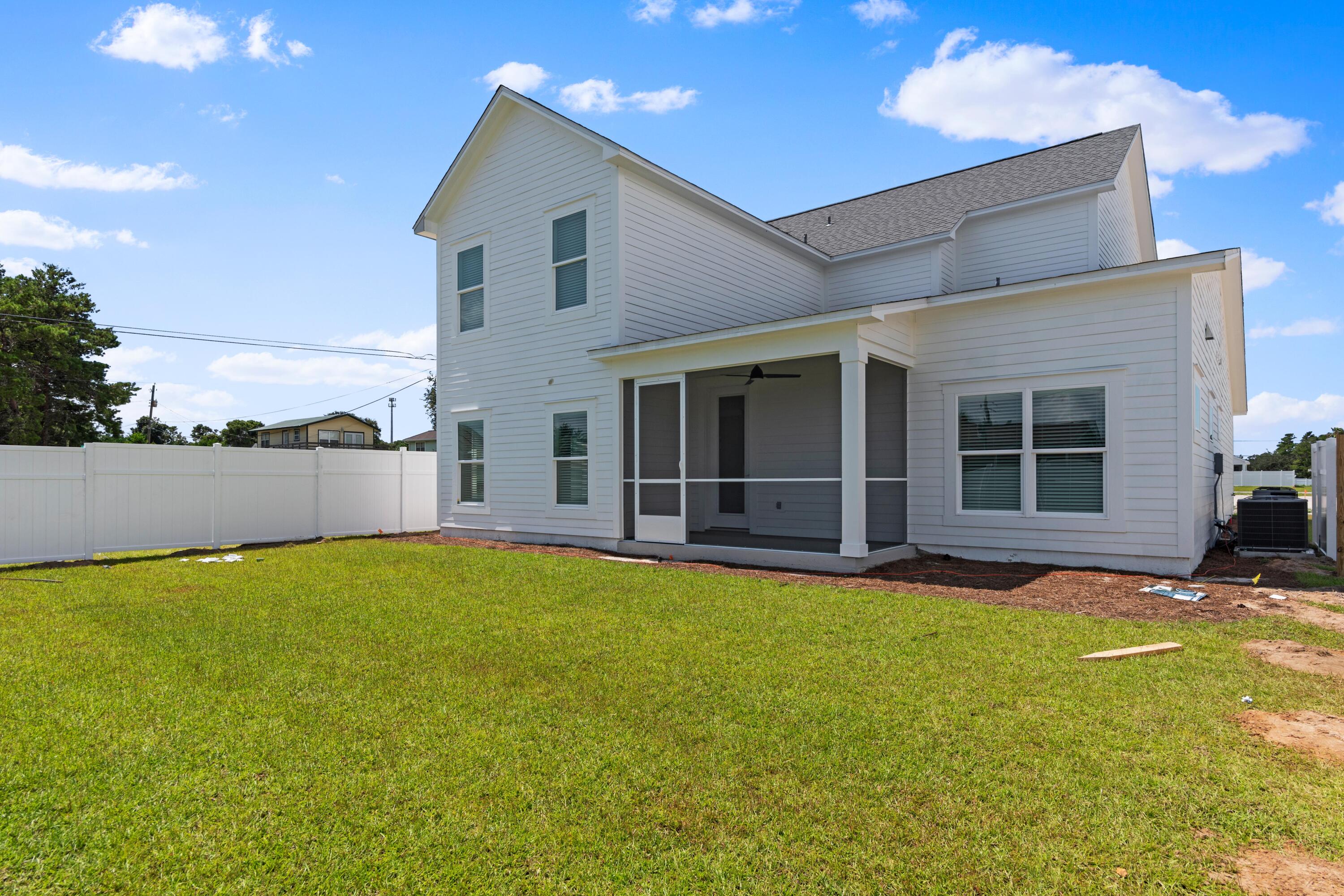 22801 Ann Miller Road Panama City Beach, FL 32413 - Photo 26 of 52 a view of a house with swimming pool and a yard