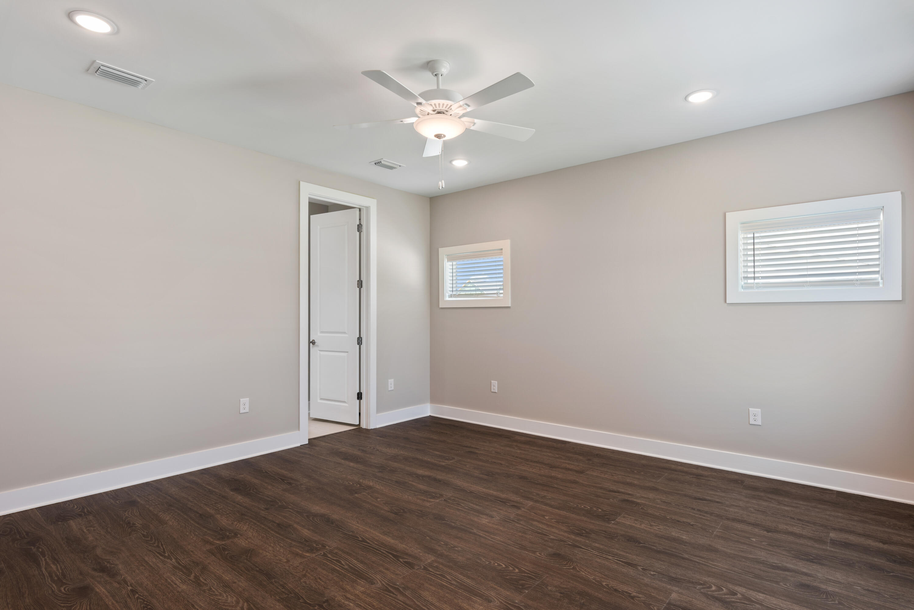22801 Ann Miller Road Panama City Beach, FL 32413 - Photo 7 of 52 a view of an empty room with wooden floor