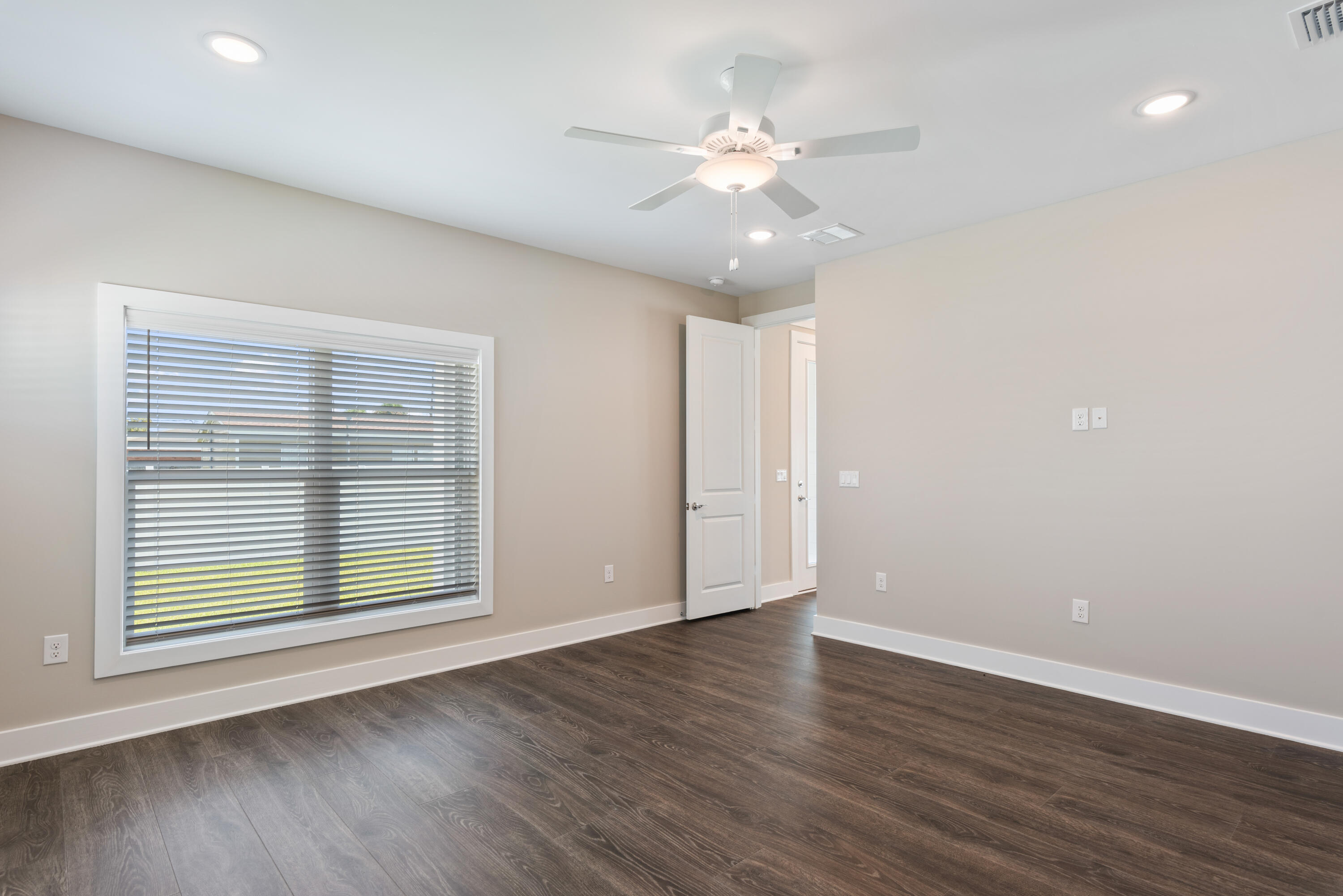 22801 Ann Miller Road Panama City Beach, FL 32413 - Photo 8 of 52 an empty room with wooden floor and windows