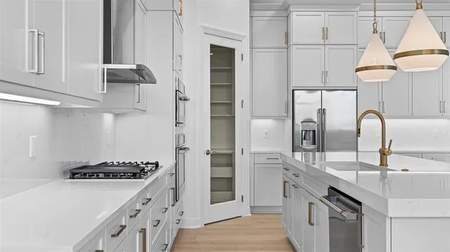 a kitchen with stainless steel appliances a sink and a stove