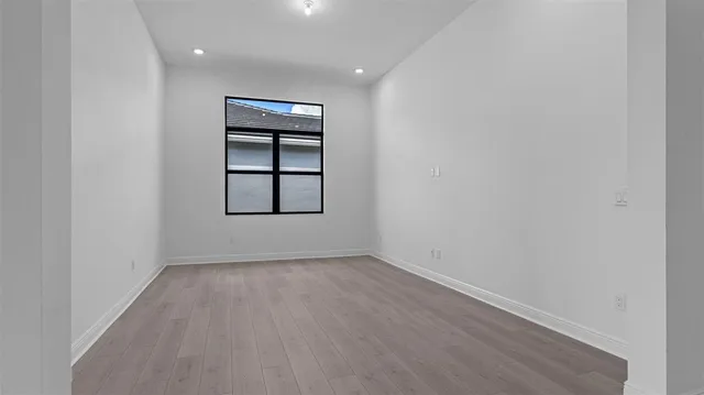 an empty room with windows and closet