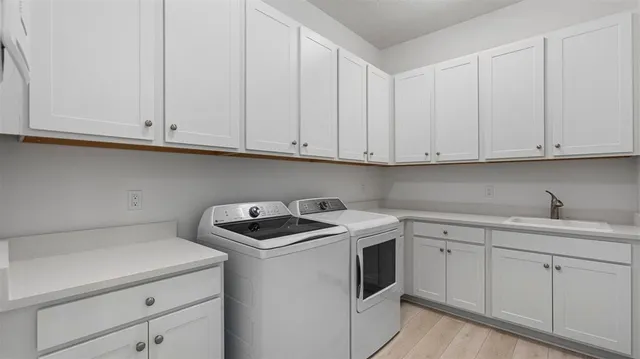 a kitchen with white cabinets and white appliances