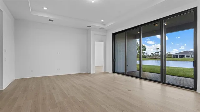 an empty room with sliding glass door and an outdoor view