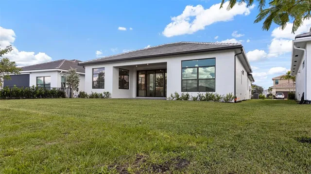 a view of a house with a backyard