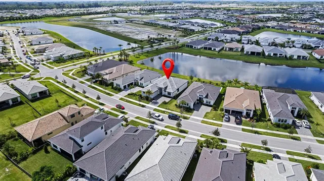 an aerial view of a house with a swimming pool and outdoor space