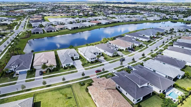 an aerial view of a house with a lake