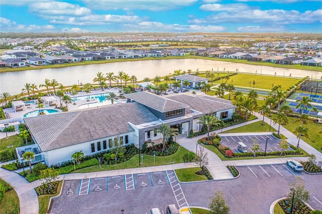 an aerial view of residential houses with outdoor space and ocean view