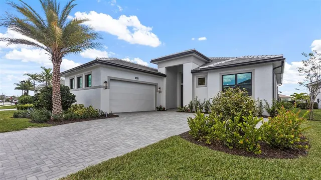 a front view of house with yard and trees around