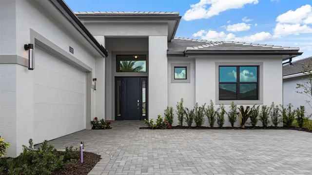 a view of a house with potted plants