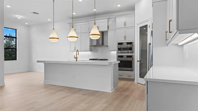 a large kitchen with cabinets and a stainless steel appliances