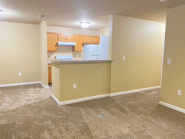 a view of a kitchen with wooden floor