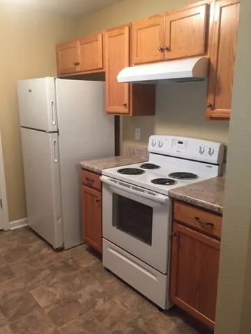 a kitchen with a stove and a refrigerator
